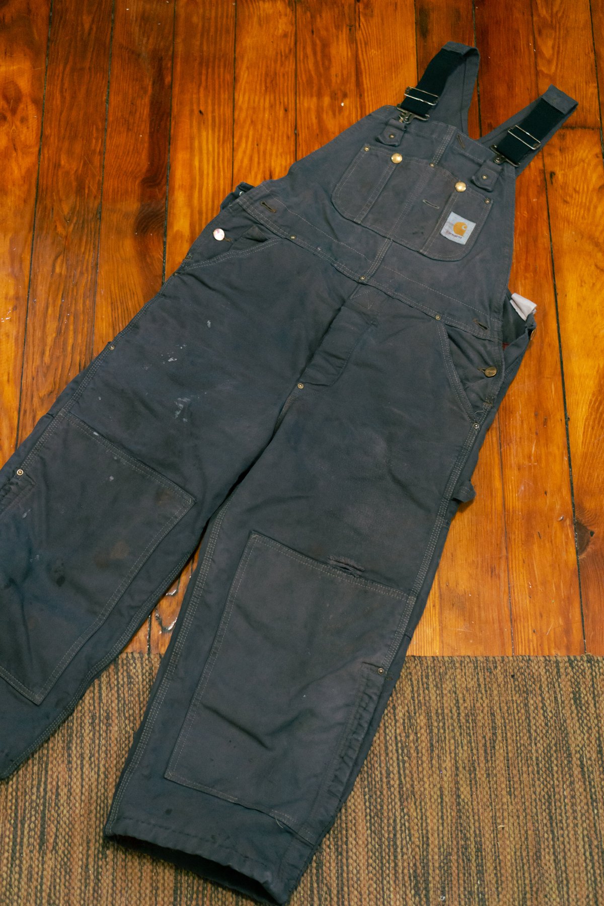 dark gray overalls with a patina of wear