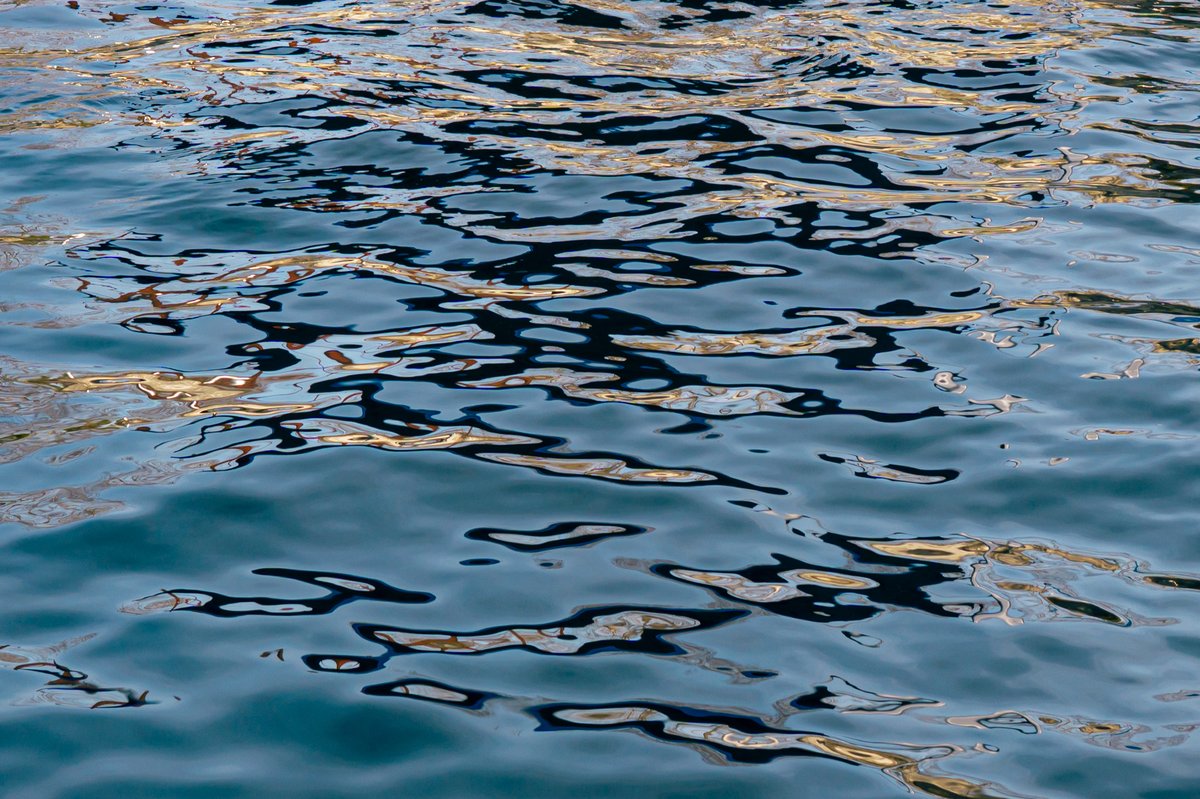 cropped pattern of the reflective surface of water outdoors