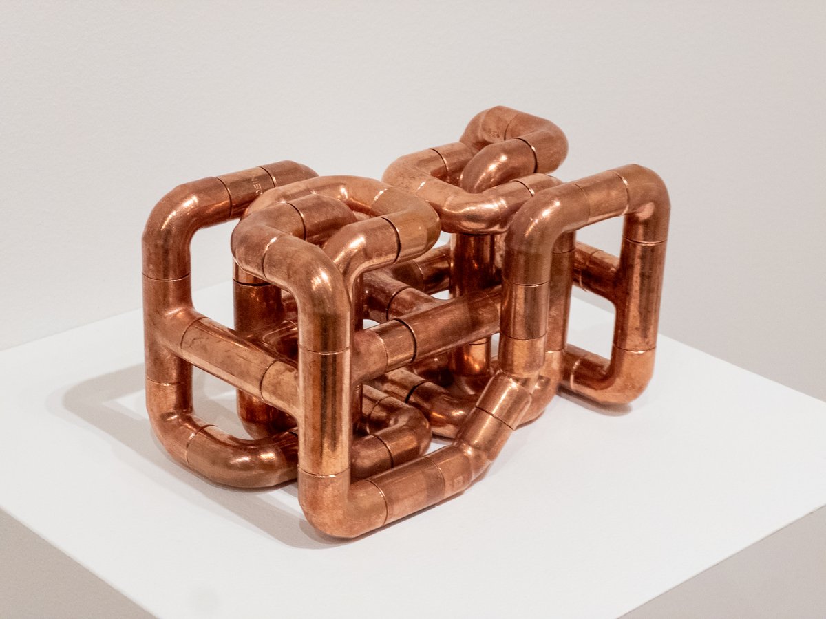 sculpture made from copper pipe elbow shapes