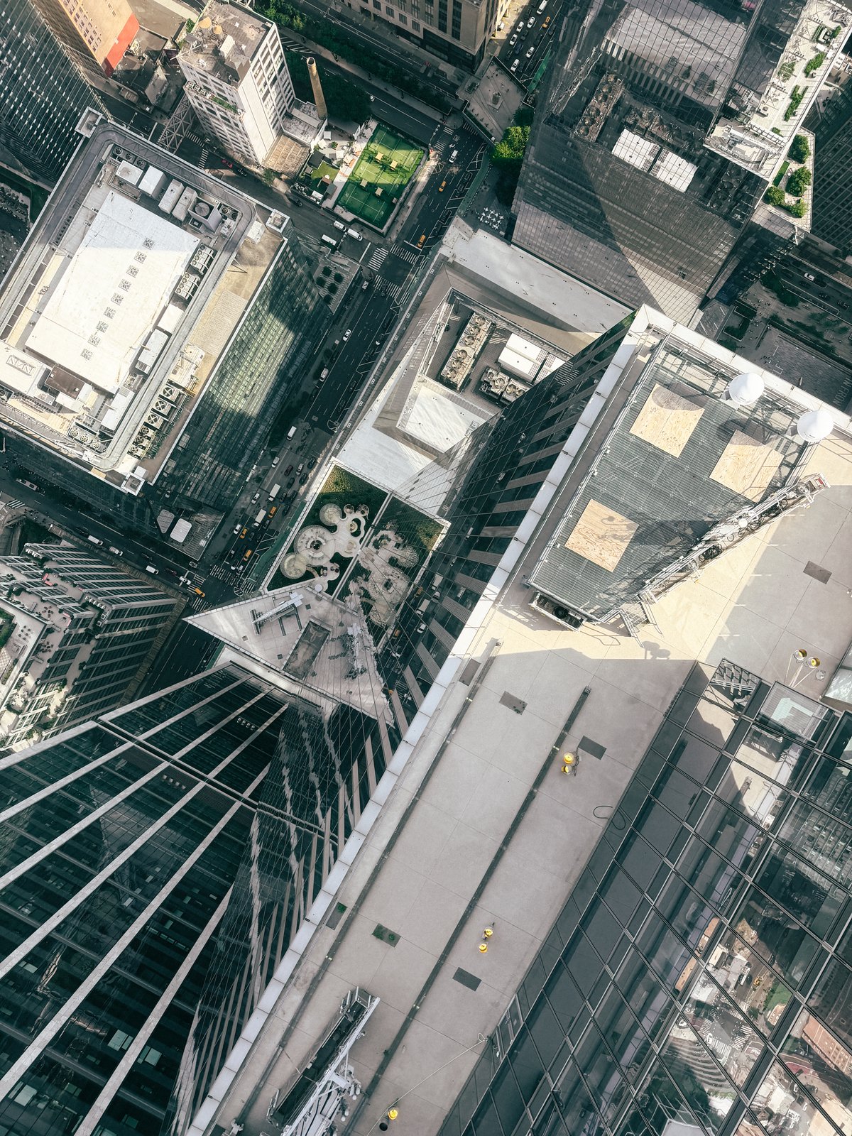 buildings from directly above, seen through the glass floor of a viewing tower