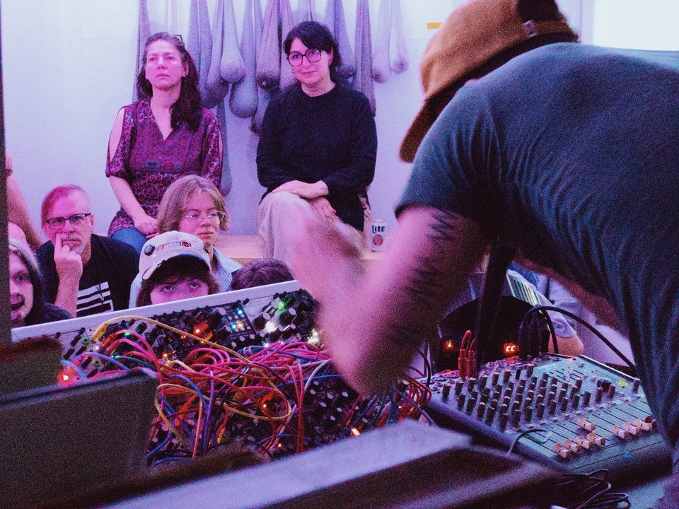 a person performing on a modular synth