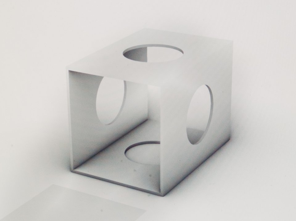 a grayscale 3D rendering of a cube with circular holes in the walls