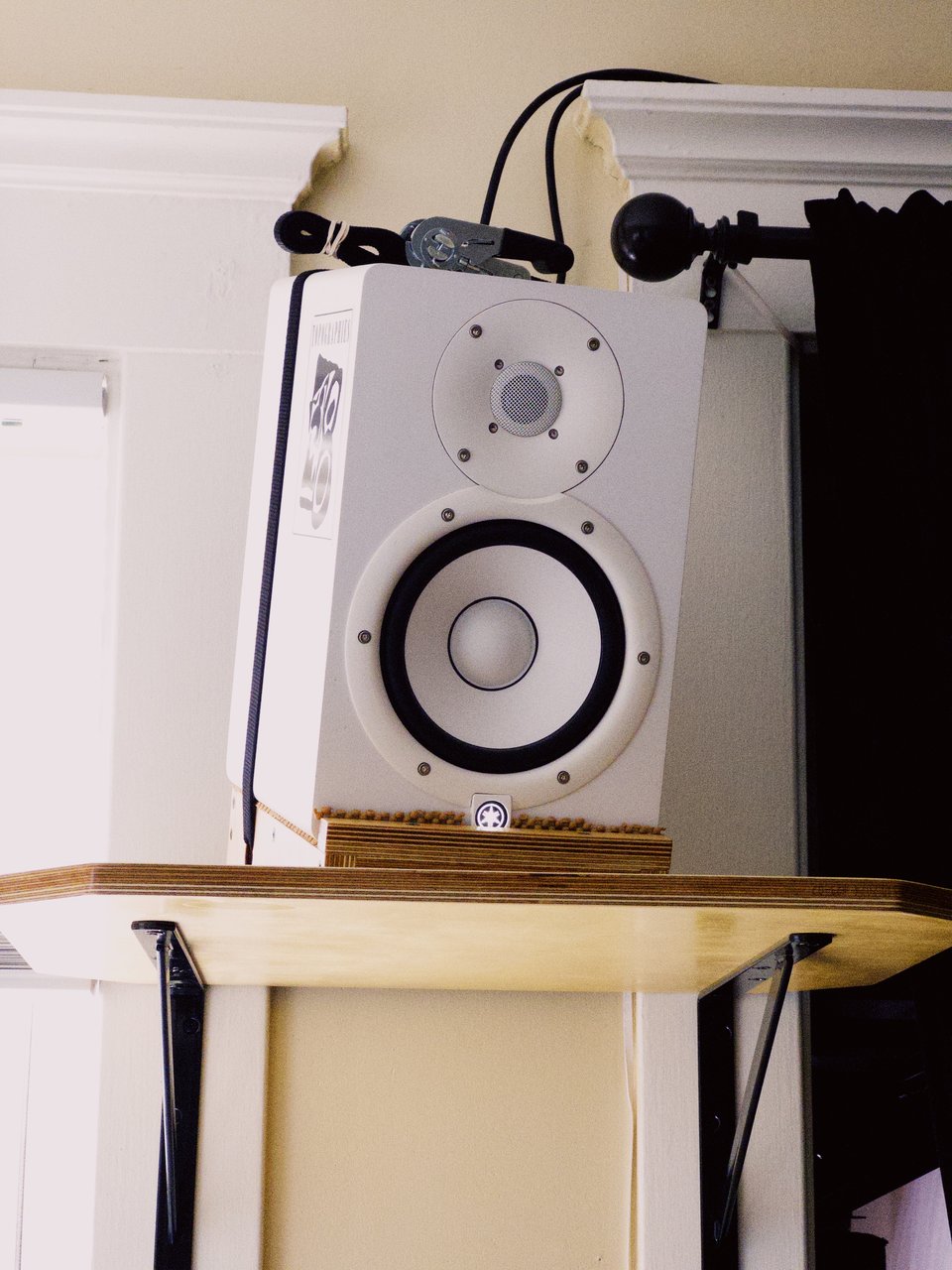 a white speaker on an angled stand