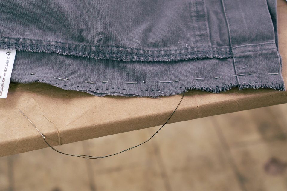 close up on a seam being sewn into gray cloth