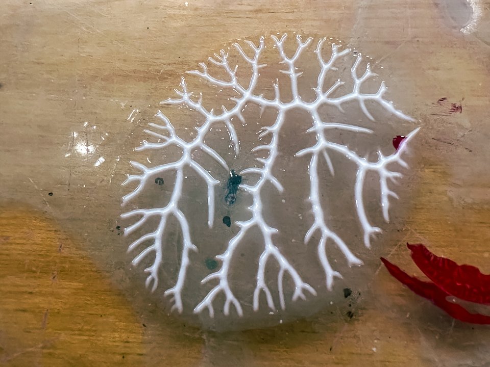 a cool pattern made by soft gel gloss stuck under a flat object