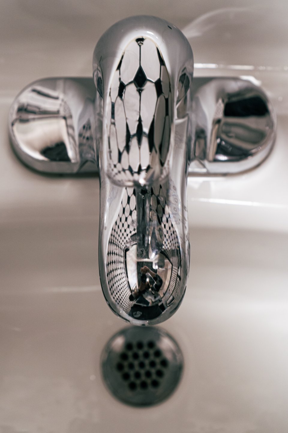 trippy hyperbolic reflection in a sink faucet