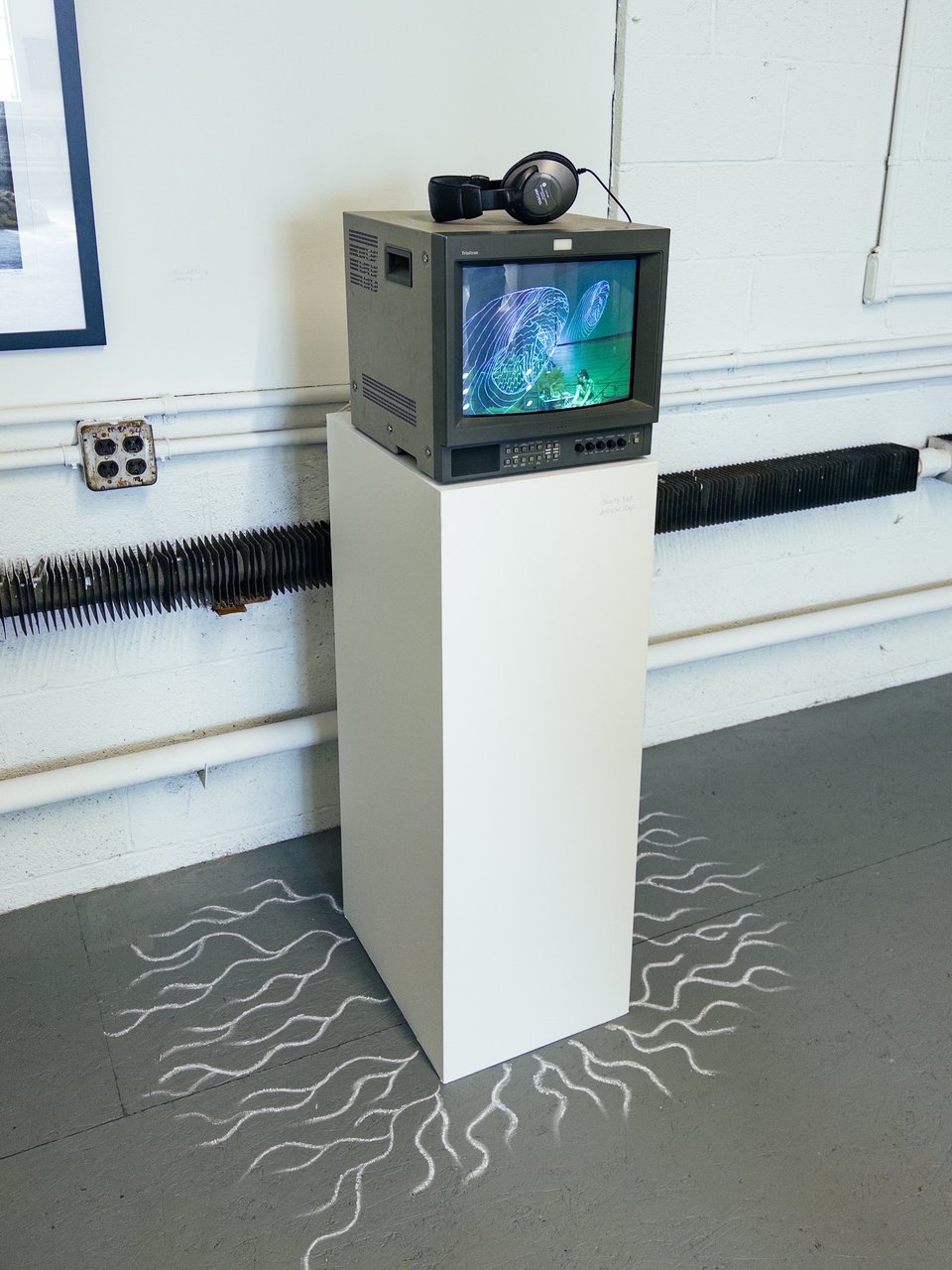 our art installation at ely center for the group show, it's a CRT with a video playing on it, headphones, and a chalk drawing of fractal root patterns on the floor