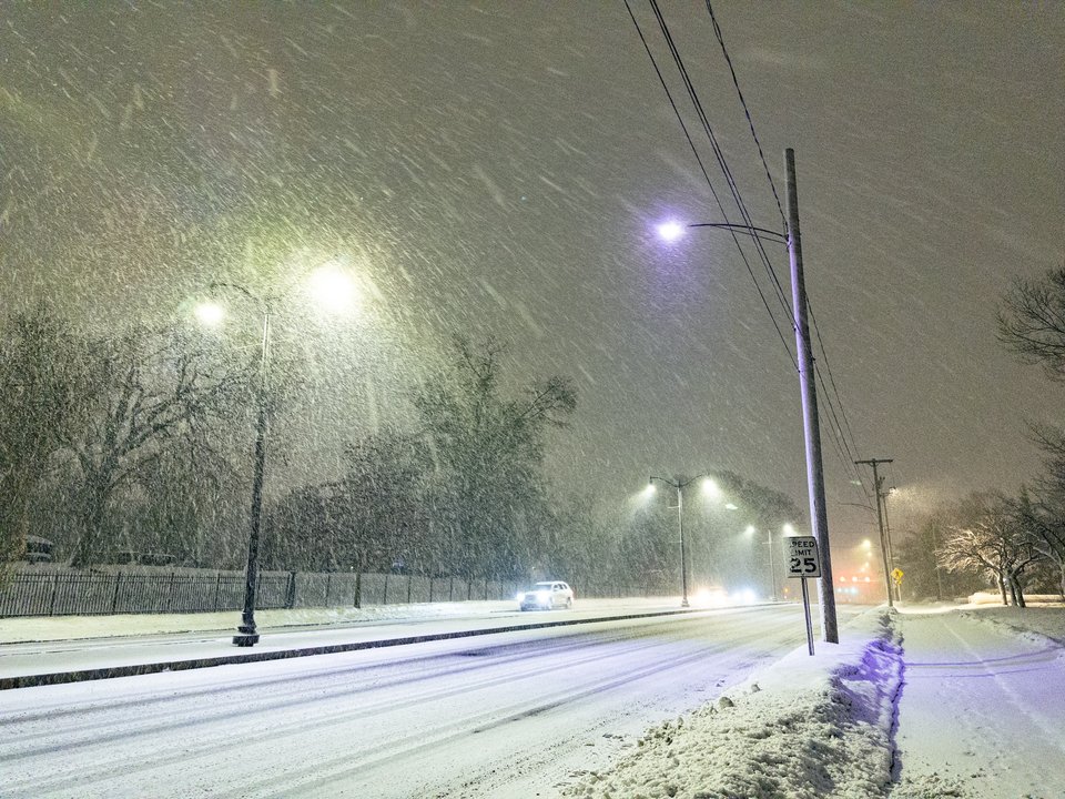 snowfall illumunated by streetlamps at night