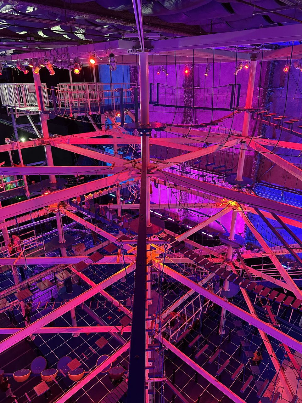 a ropes course in blacklight lighting
