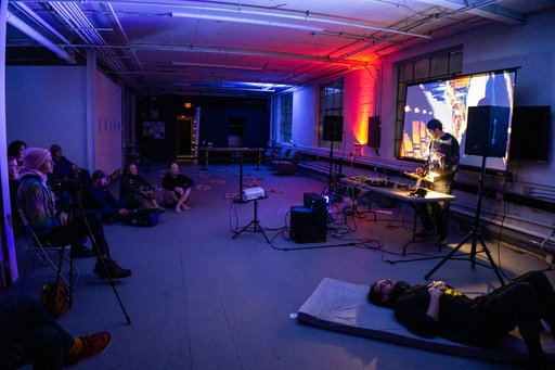 chance voyage performing, our friend john is lying on a mat in the foreground