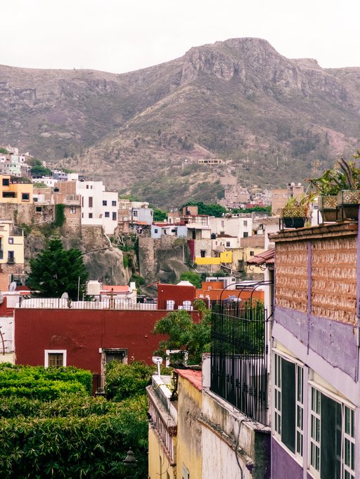 buildings and plaza below, mountains above