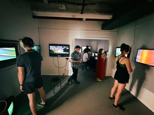 people looking at video screens in an art gallery