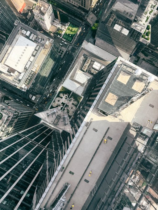 buildings from directly above, seen through the glass floor of a viewing tower